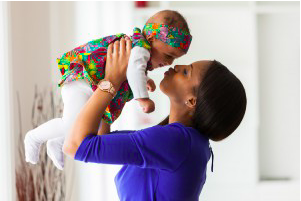 Woman holding baby in the air