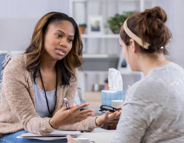  A patient and health care provider sit and talk