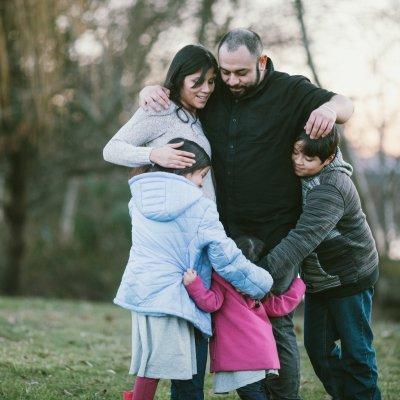 The Rodriguez family hugging one another