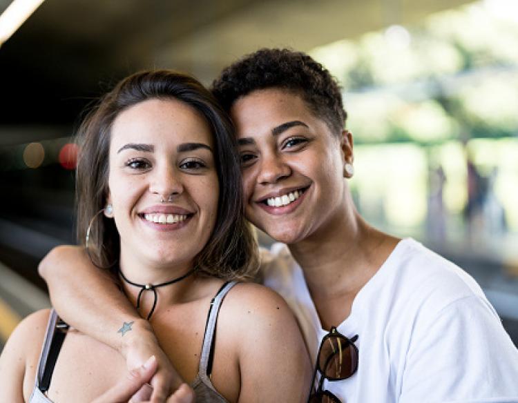 Couple with arms linked and smiling.