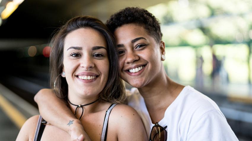 Couple with arms linked and smiling.