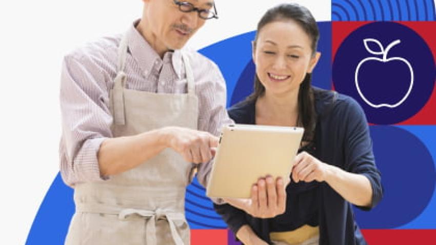 Man and woman looking at a tablet together.